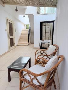 a patio with two chairs and a table and stairs at Kabeel's House in Dahab