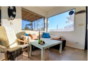 a living room with a couch and a table at YellowStone in Balneario Buenos Aires