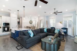 a large living room with a couch and a kitchen at Isle be 'SEA'ing You in Inlet Beach