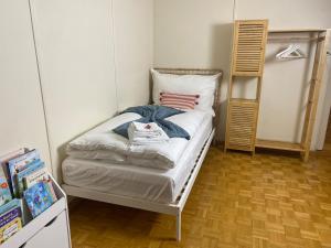 a small bedroom with a bed in a room at Cara Nima Schwyz in Schwyz