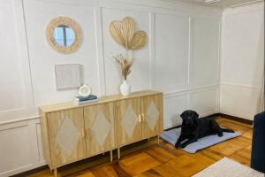 a black dog laying on a rug in a room at Cara Nima Schwyz in Schwyz