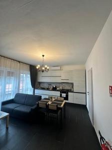 a living room with a blue couch and a table at Dante appartamento 1 in Fagnano Olona