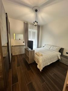 a bedroom with a bed and a television in it at Dante appartamento 1 in Fagnano Olona