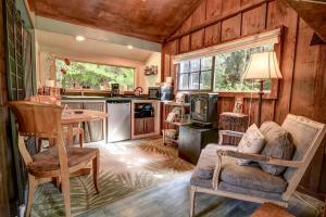 a kitchen with a couch and a table in a room at Volcano Artist Cottage in Volcano