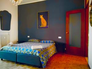 a bedroom with a bed with a cat painting on the wall at Charming Central Relais in Bergamo