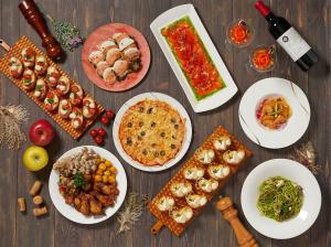 a wooden table with plates of food on it at Hotel Green Plaza Hakuba in Otari