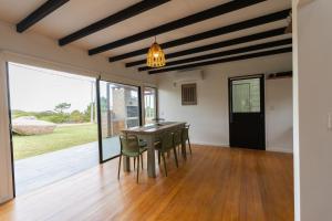 a dining room with a table and chairs at Orion in Punta Del Diablo +26 photos
