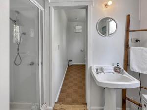 a white bathroom with a sink and a shower at Halcyon Days in St Helens +23 photos