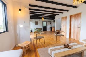 a living room with a table and chairs at Orion in Punta Del Diablo