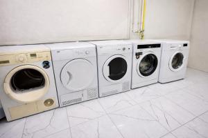 three washing machines and a washer and dryer in a room at Valentina Apart Hotel in Istanbul