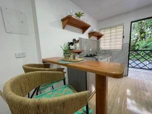 a kitchen with a wooden table and chairs at Posada Kotnat in San Andrés