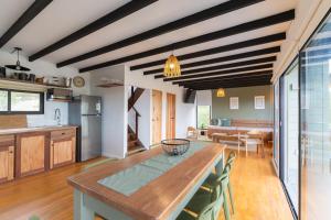 a kitchen and dining room with a table and chairs at Orion in Punta Del Diablo