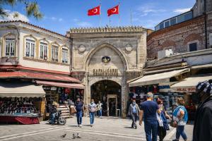 a group of people walking through a market with two canadian flags at Valentina Apart Hotel in Istanbul