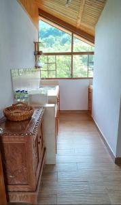 a kitchen with a sink and a large window at Mindo Suites in Mindo +1 photo