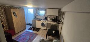 a small kitchen with a washing machine and a washer at Small, cozy tiny apartment, complete in Lichtenau