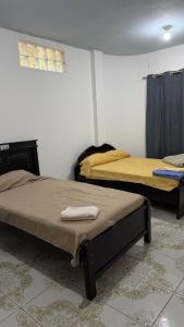 a bedroom with two beds in a room at Casa JIREH in Puerto Ayora +7 photos