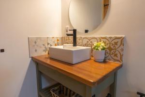 a bathroom with a sink and a mirror at Orion in Punta Del Diablo