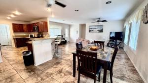 a kitchen and living room with a table and chairs at 2BR 1BA Blissful Orchard in Keaau