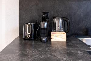 a counter top with a coffee maker and a blender at Lea Apartement - Ruhiges Studio in Schaffhausen