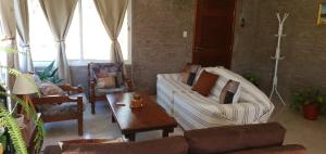 a living room with two couches and a coffee table at Casa en Punta Colorada con gran fondo y fogón in Punta Colorada
