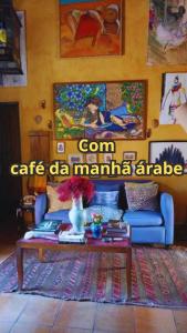 a living room with a blue couch and a coffee table at Vila Santa Rosa in Ilhabela