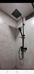 a shower in the corner of a room at Las casitas de Canggu in Canggu