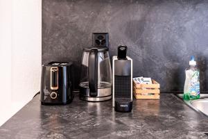 a coffeemaker and a coffee maker on a counter at Josephines Studio in Schaffhausen +29 photos