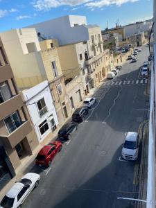 an aerial view of a street with parked cars at Adinkra Suits in Ħal Balzan
