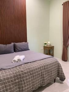 a bedroom with a bed with a towel on it at RusanHome Pengkalan Chepa in Pengkalan Cepa