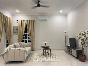 a living room with a couch and a ceiling fan at RusanHome Pengkalan Chepa in Pengkalan Cepa