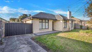 a house with a fence in a yard at Sunnybank House with EV Charger in Cheltenham