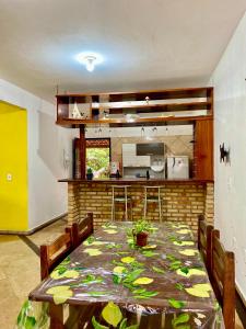 una sala da pranzo con un tavolo e una cucina di Casa Caju a Aracati Altre 10 foto
