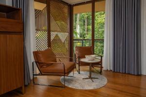 two chairs and a table in a room with a window at Tifakara by the Waterfall in Fortuna +61 photos