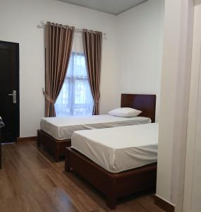 En eller flere senge i et værelse på Pandava House Lombok