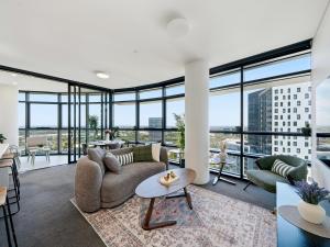 a living room with a couch and a table at The Sky Perch in Sydney
