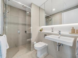 a bathroom with a toilet and a sink and a shower at The Sky Perch in Sydney