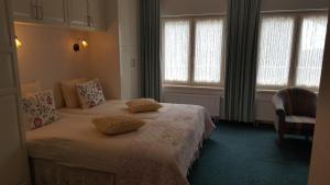 - une chambre avec un lit et 2 oreillers dans l'établissement Het Uilenbos, à De Koog