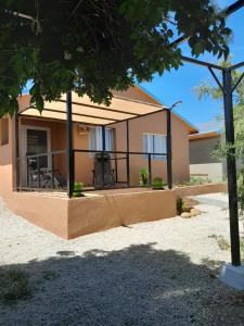 a house with a fence around the front of it at Cabañas Los Teros in Aluminé