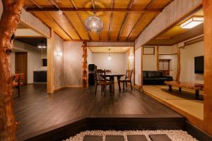 a dining room and living room with a table and chairs at 樹-Itsuki- "岩風呂付 rockbath" in Hakone