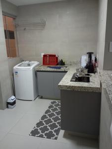 a kitchen with a stove and a counter top at Conforto setor Oeste garagem 505 in Goiânia
