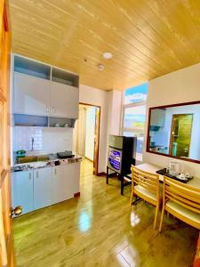 a kitchen with a table and a dining room at Nica's Palace Baguio in Baguio