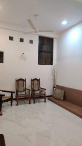 a living room with two chairs and a couch at Cinnamon Shade by Achievers in Negombo