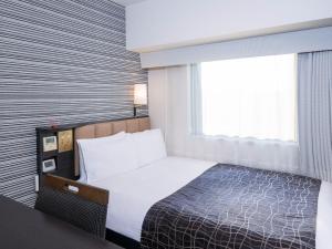 En eller flere senge i et værelse på APA Hotel Keisei Ueno Ekimae
