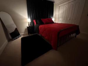 ein Schlafzimmer mit einem roten Bett und einem Stuhl in der Unterkunft Hotness in Chandernagore Settlement