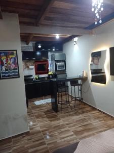 a kitchen with a desk and a counter top at Chalé Vista da Serra in Pedro II