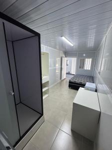 En eller flere senge i et værelse på Residencial Manhattan