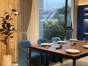 a dining room with a table and blue chairs at TS Villa in Danang