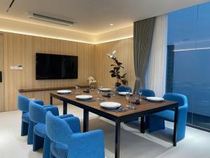a dining room with a table and blue chairs at TS Villa in Danang