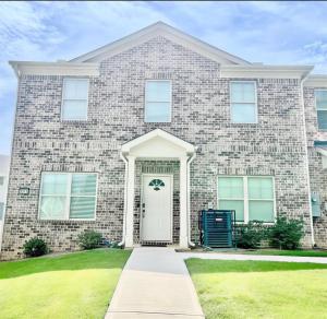 a large brick house with a white door at The Aristocrat's Abode in Stockbridge