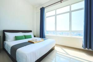 a bedroom with a bed and a large window at NOVO 8 Residence Melaka in Malacca